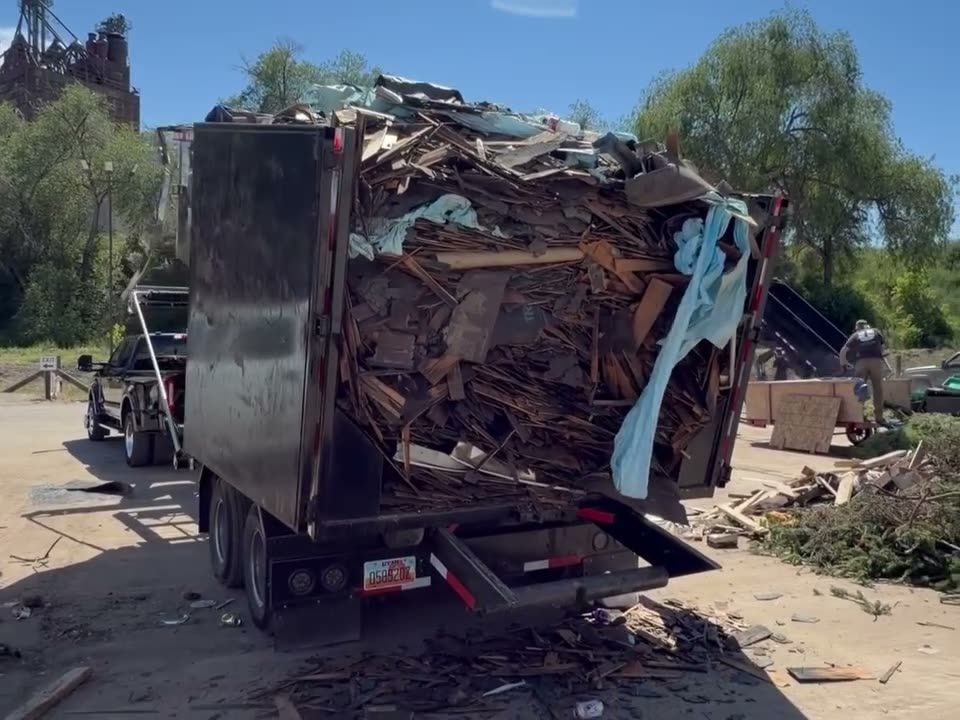 Triple R Dump trailer loaded with demolition debris at a dump site