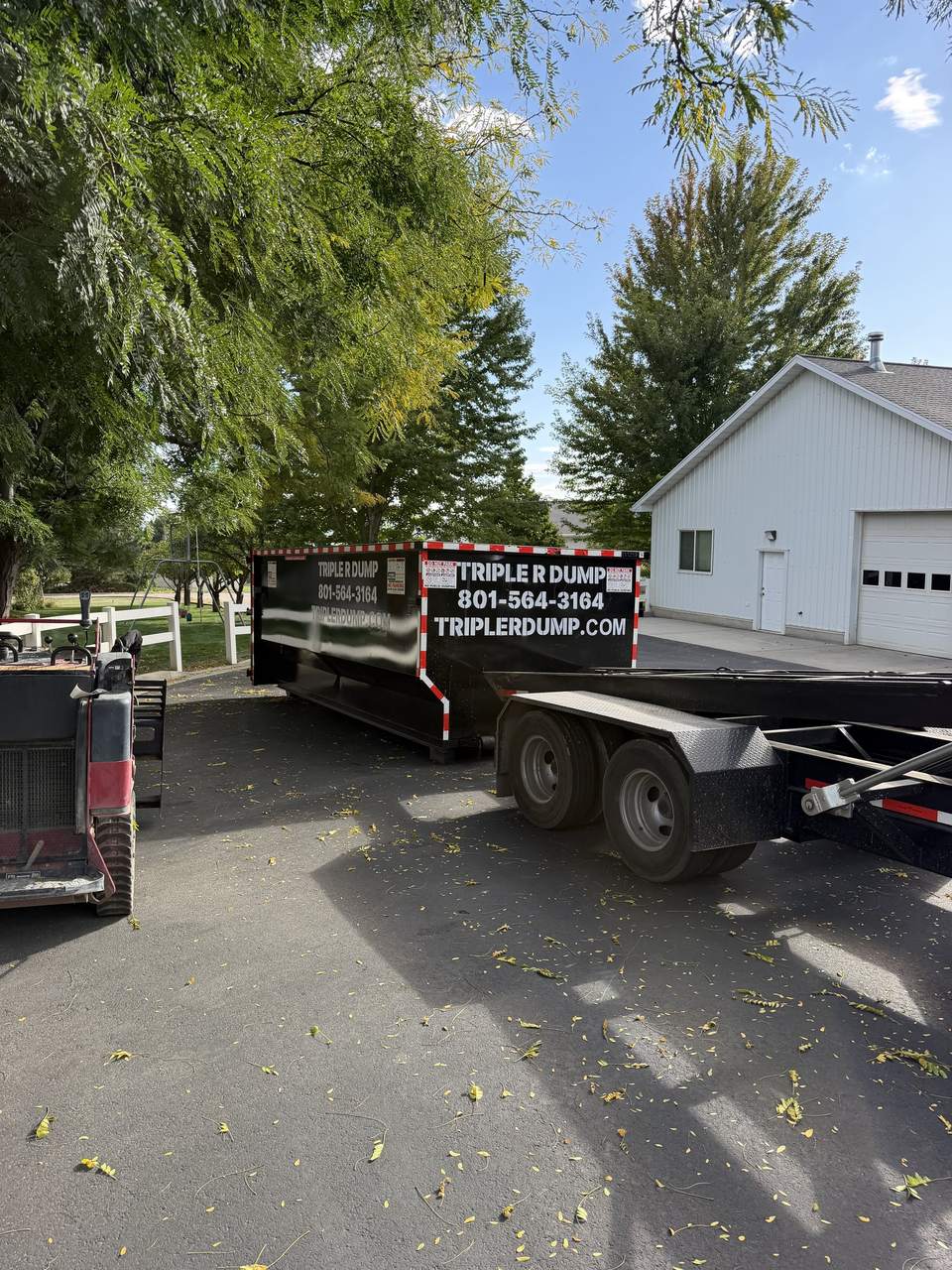 Triple R Dump roll-off dumpster dropped off at a home in North Ogden, Utah